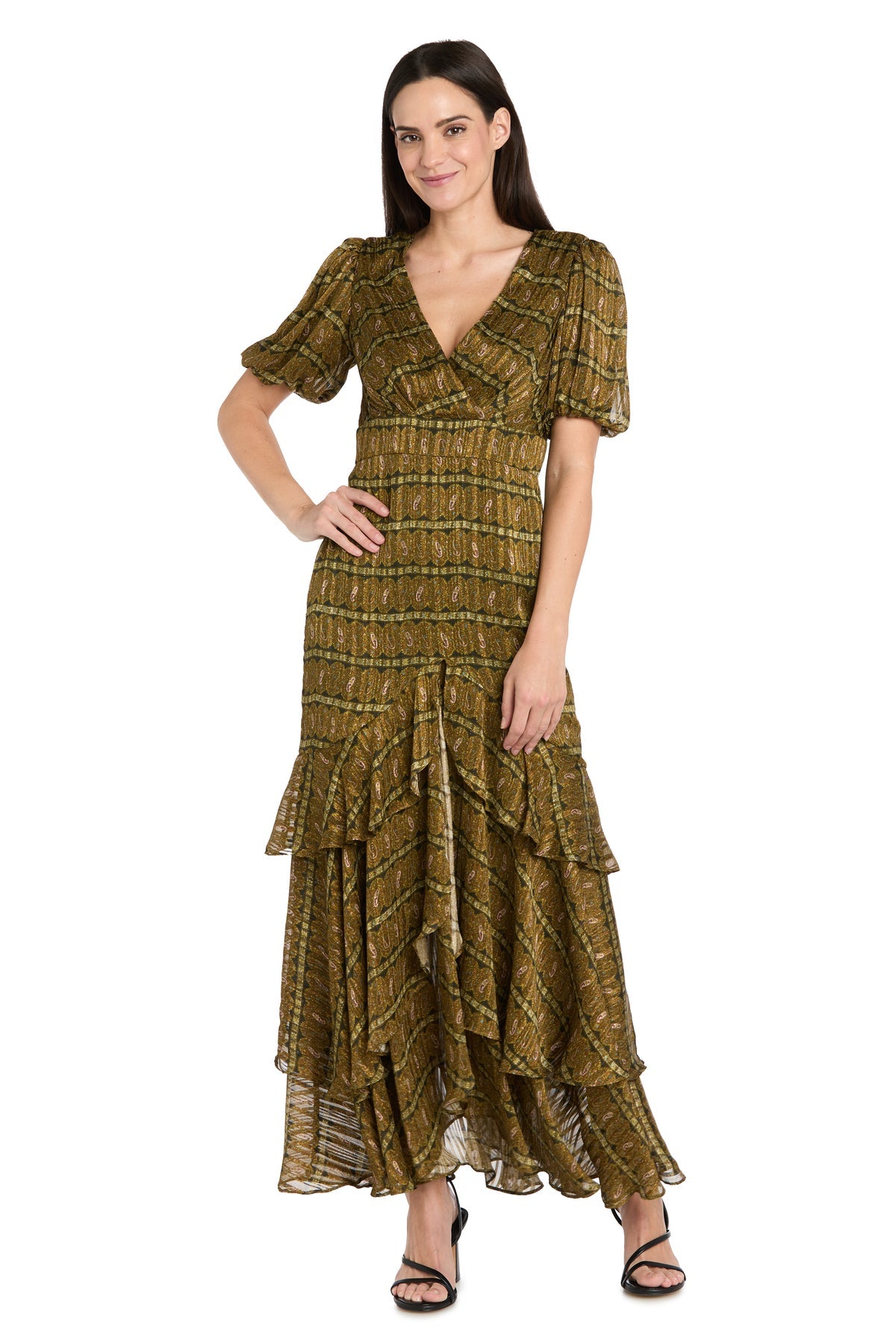 A woman stands wearing the R&M Richards 4157 long plaid wedding guest dress with short sleeves, a V-neck, tiered ruffle maxi design, gold patterns, and black heeled sandals.